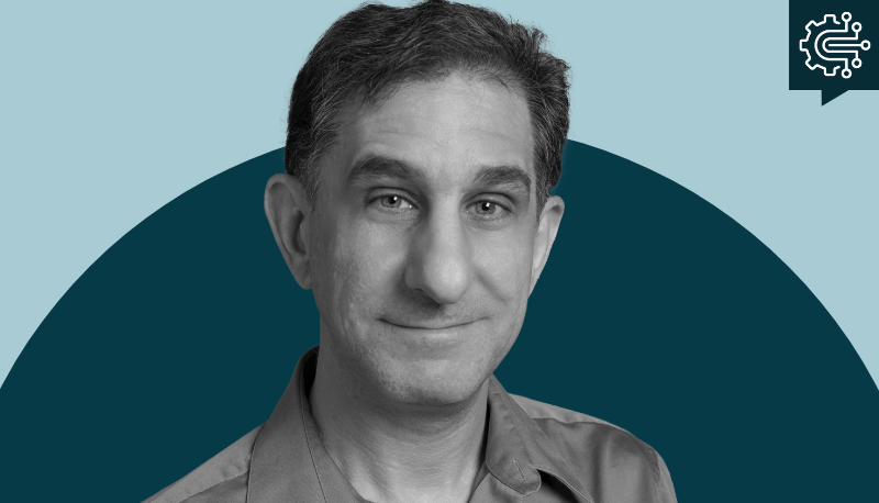 black and white headshot of David Hart on a two-tone blue background